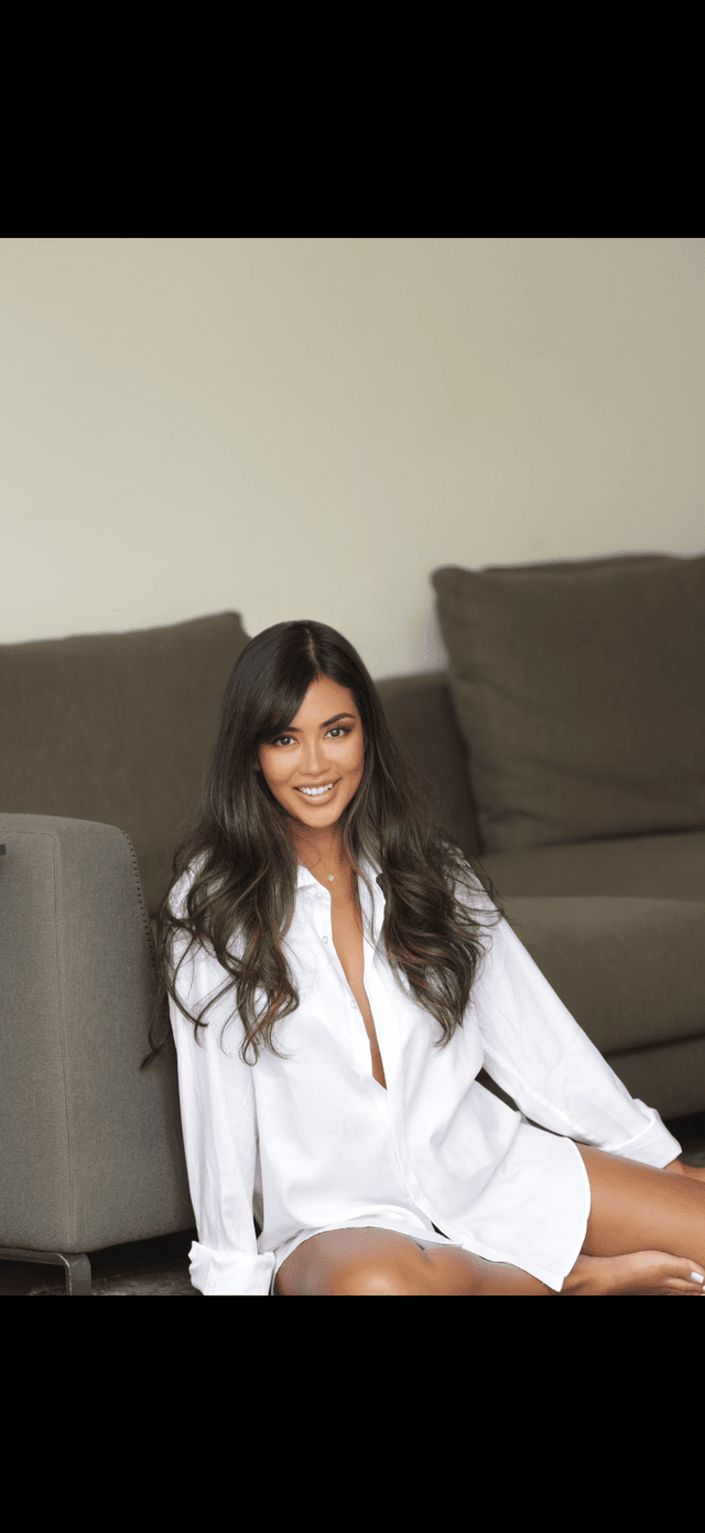 Woman in white shirt smiling sitting down